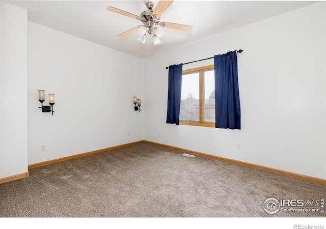 carpeted empty room featuring ceiling fan