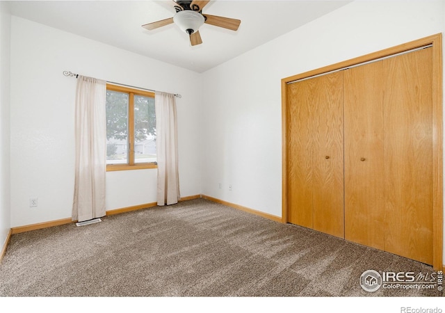 unfurnished bedroom featuring carpet floors, a closet, and ceiling fan