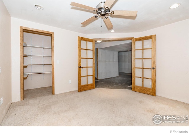 unfurnished bedroom featuring ceiling fan, a closet, carpet floors, and french doors