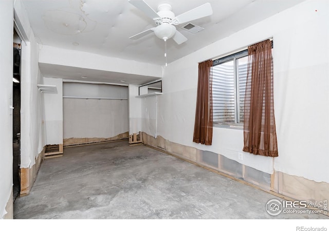 interior space with ceiling fan and a closet