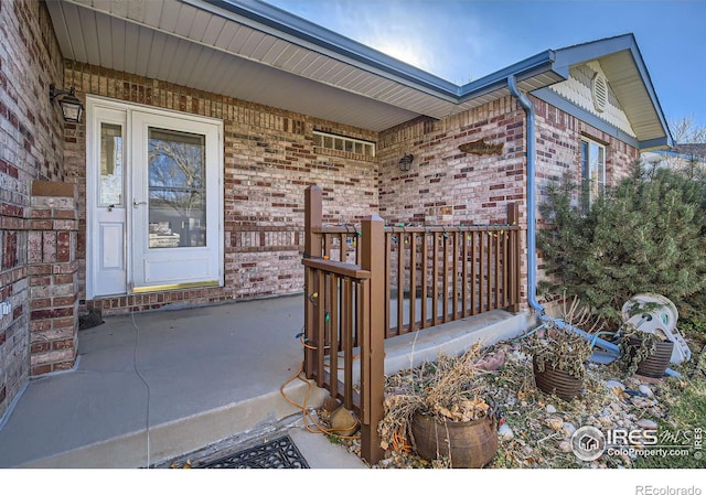 view of exterior entry with covered porch