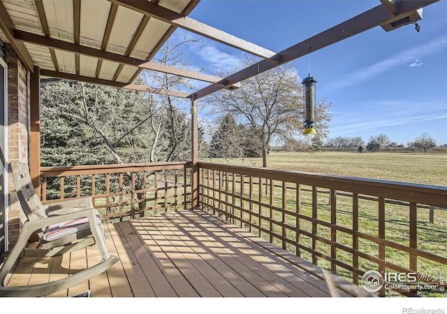 wooden deck featuring a lawn