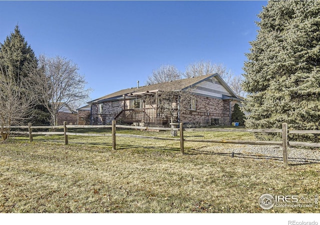 view of front of house with a wooden deck and a front lawn