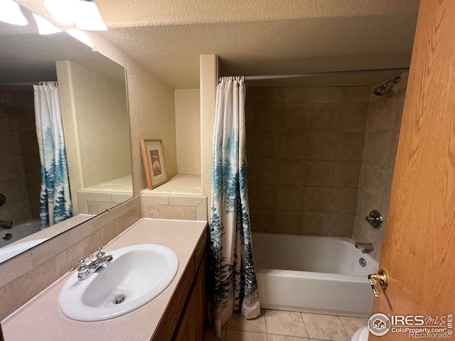 bathroom with shower / bath combination with curtain, tile patterned flooring, sink, and a textured ceiling