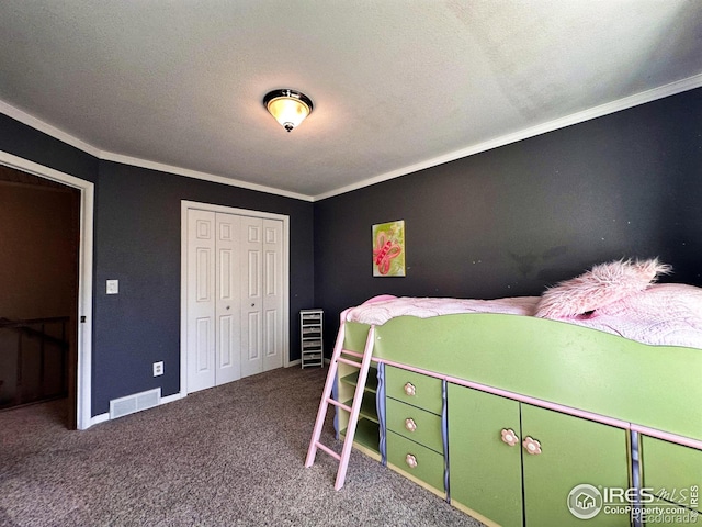 bedroom featuring carpet, a textured ceiling, a closet, and crown molding