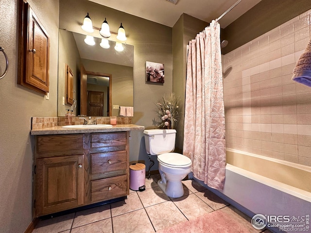 full bathroom featuring toilet, vanity, tile patterned floors, and shower / bath combo with shower curtain