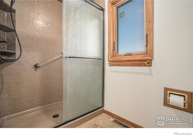 bathroom featuring an enclosed shower