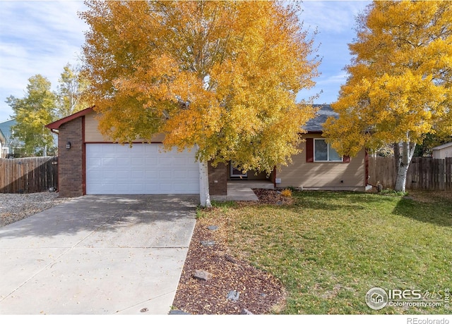 obstructed view of property with a garage and a front yard