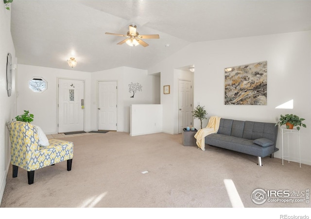 carpeted living room with vaulted ceiling and ceiling fan