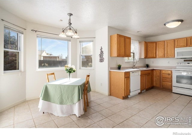 kitchen with pendant lighting, sink, white appliances, a textured ceiling, and light tile patterned flooring