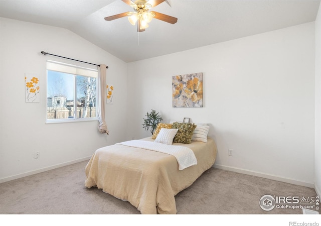 bedroom featuring vaulted ceiling, light colored carpet, and ceiling fan