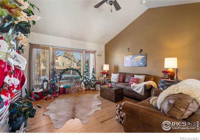 living room with light hardwood / wood-style floors, vaulted ceiling, and ceiling fan