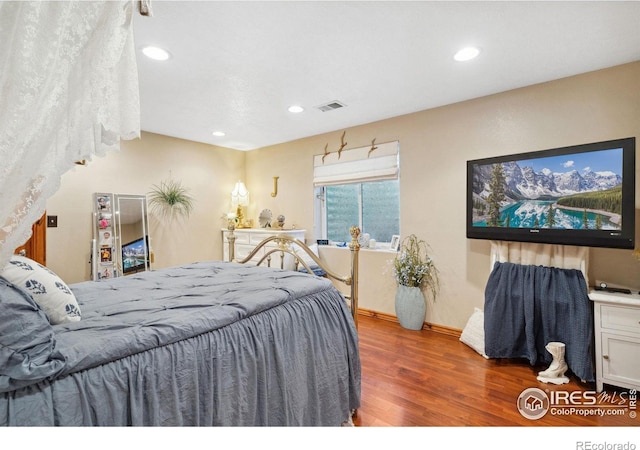 bedroom with dark hardwood / wood-style floors