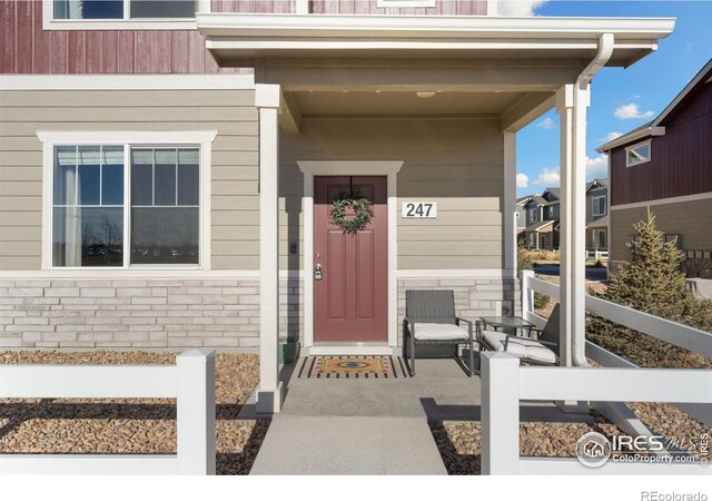 doorway to property featuring covered porch