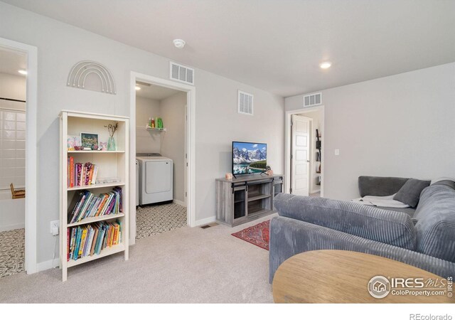 living room with light colored carpet and washer / clothes dryer