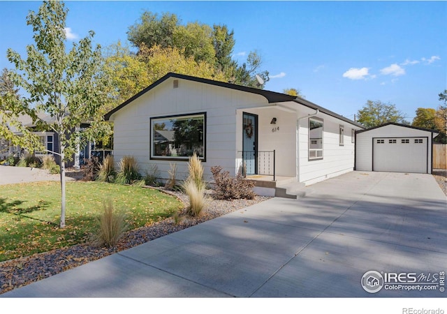 single story home with a front yard, a garage, and an outdoor structure