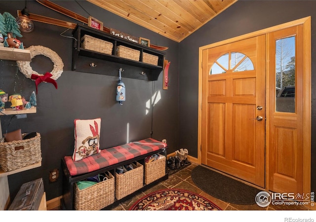 mudroom with dark tile patterned flooring, lofted ceiling, and wood ceiling