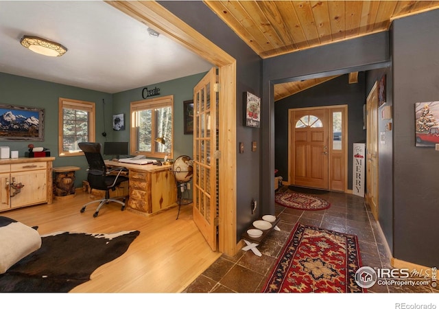 entrance foyer with dark hardwood / wood-style flooring, vaulted ceiling, and wooden ceiling