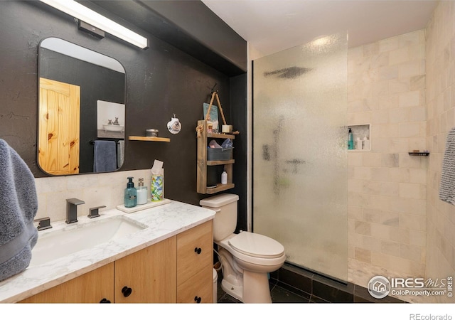 bathroom featuring walk in shower, tile patterned floors, backsplash, toilet, and vanity