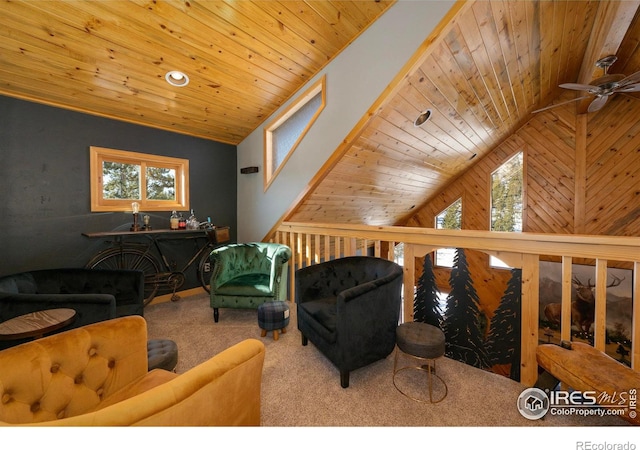 carpeted living room featuring high vaulted ceiling, ceiling fan, wood ceiling, and wooden walls