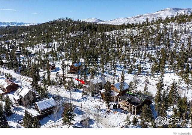 snowy aerial view with a mountain view