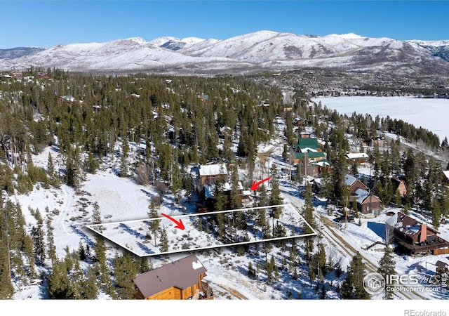 snowy aerial view featuring a mountain view