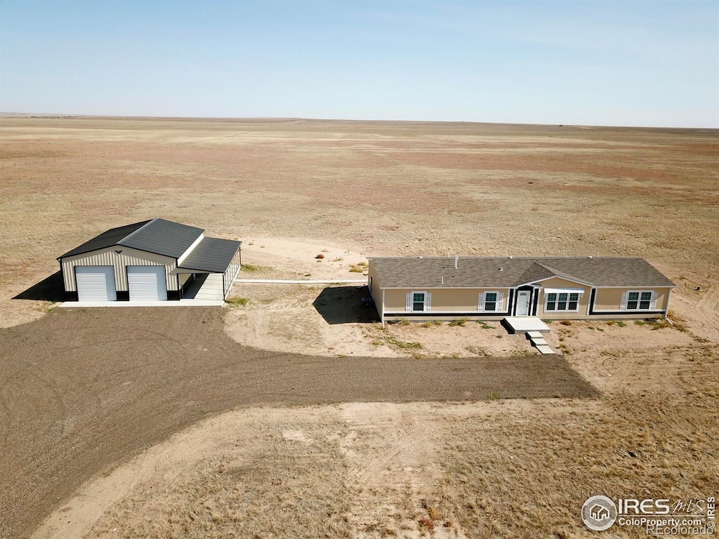 view of front of property with a garage and an outdoor structure