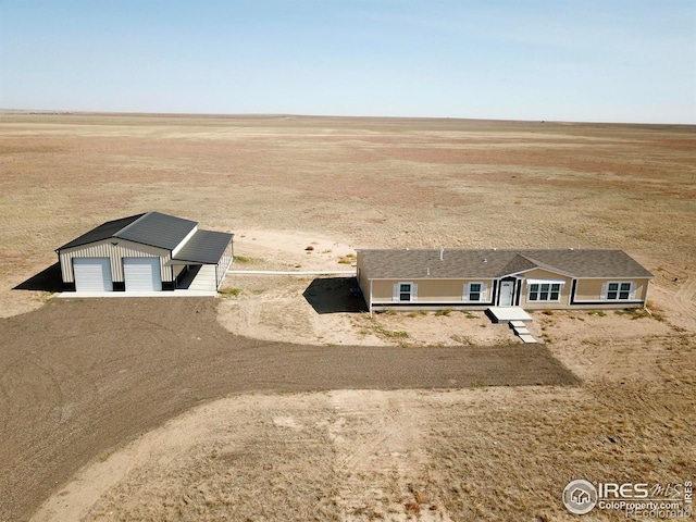 view of front of property with a garage and an outdoor structure