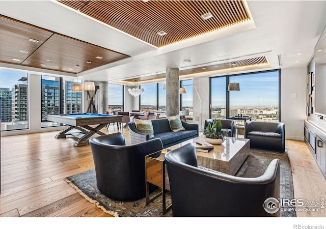 living room featuring light wood-type flooring, a wall of windows, wooden ceiling, billiards, and a chandelier