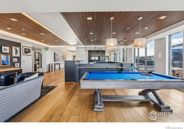 game room featuring a raised ceiling, billiards, wood ceiling, and light wood-type flooring