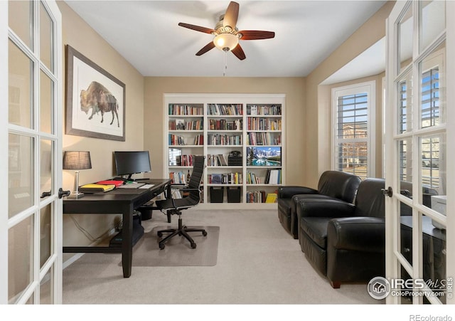 carpeted home office featuring ceiling fan and french doors