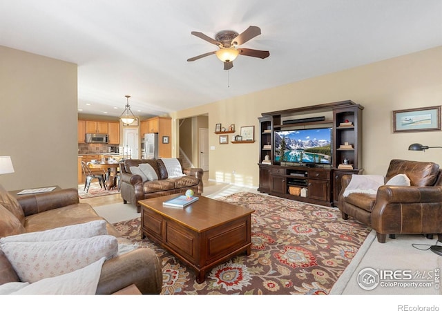 living room with ceiling fan and light carpet