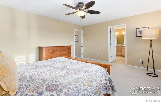 bedroom with light carpet, ensuite bath, and ceiling fan