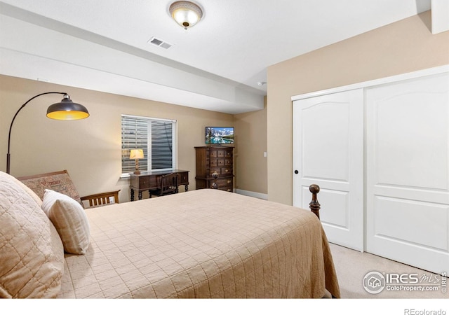 bedroom with light carpet and a closet