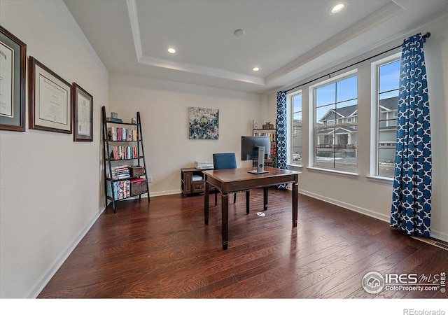 home office featuring dark hardwood / wood-style floors, crown molding, and a tray ceiling