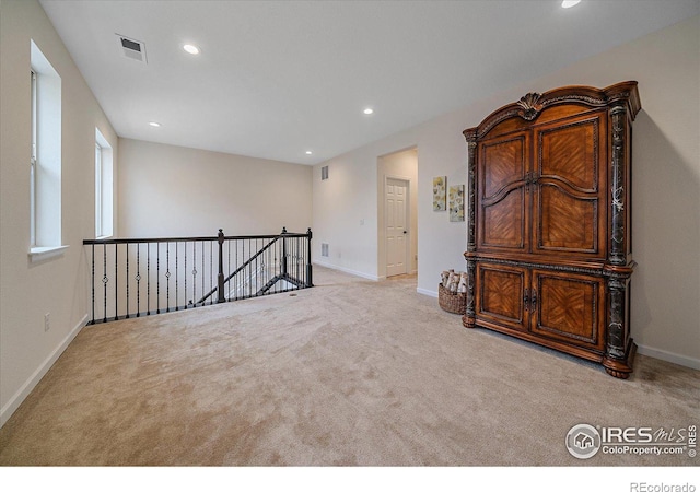 spare room featuring light colored carpet