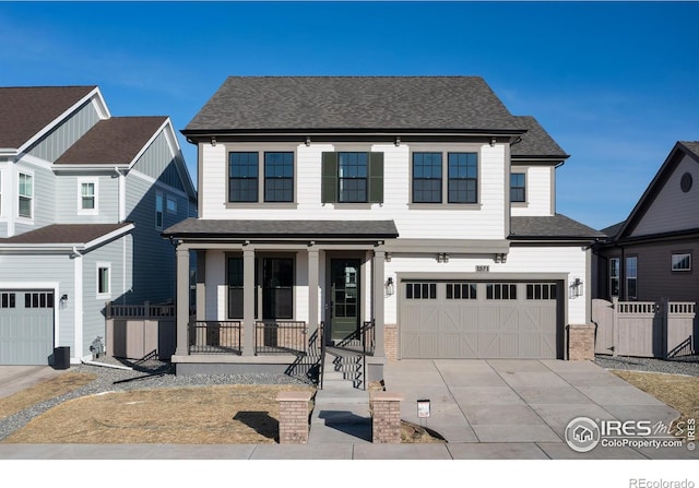 view of front of property featuring covered porch and a garage