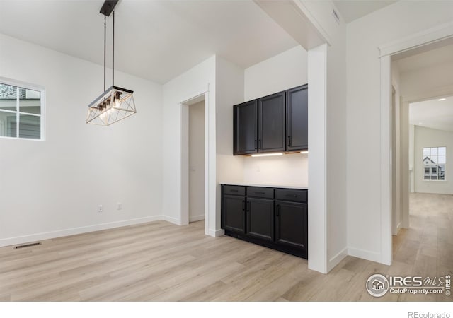 unfurnished dining area featuring light wood-type flooring