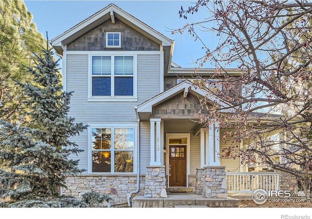 craftsman-style house with stone siding