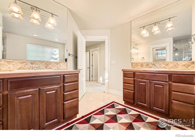 full bathroom with tasteful backsplash, two vanities, and a sink