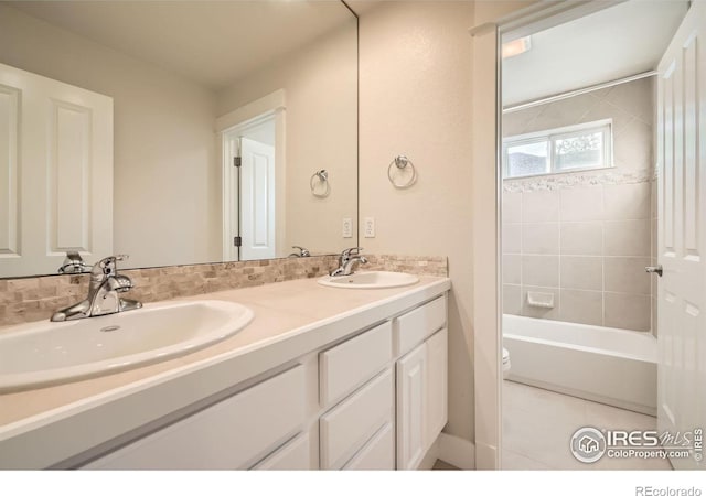 full bathroom with double vanity, shower / bath combination, toilet, and a sink