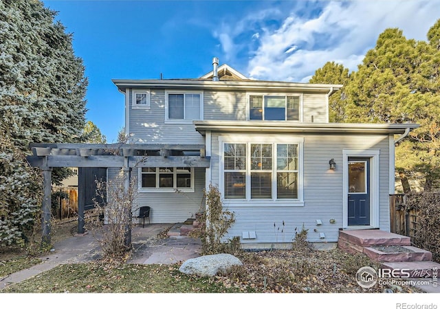 view of front of property with a patio, fence, and a pergola