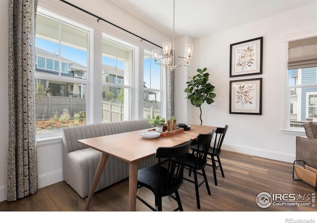 dining area featuring an inviting chandelier and dark hardwood / wood-style flooring