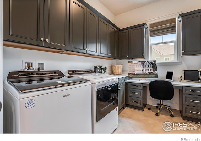 laundry room featuring washer and dryer and cabinets