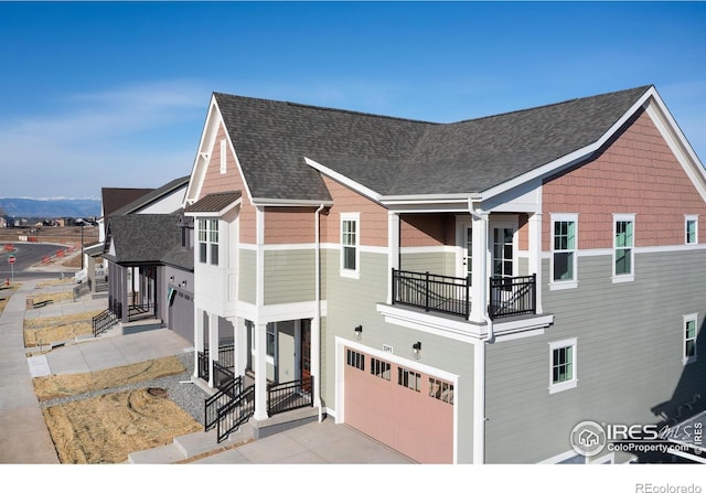 view of front of home featuring a garage and a balcony