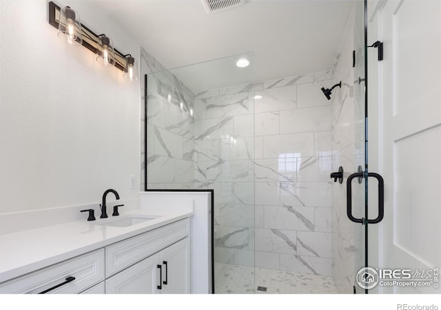 bathroom featuring vanity and a shower with shower door