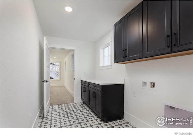 laundry area with hookup for a washing machine, cabinets, and a wealth of natural light