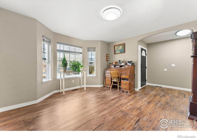 home office with wood-type flooring