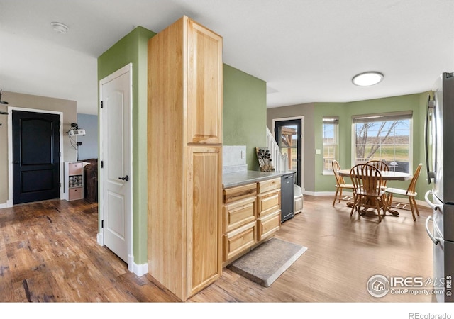 kitchen featuring light brown cabinetry, stainless steel refrigerator, and hardwood / wood-style floors