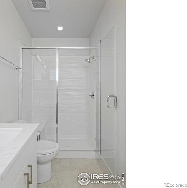 733 Kubat Ln Unit A, Longmont, CO 80503 - bathroom featuring tile patterned floors, vanity, a shower stall, and recessed lighting